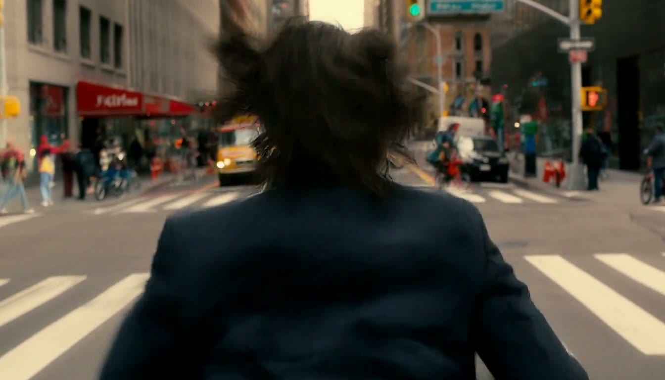 MiniMax H3 AI video example showing a man in a suit runs through a busy city street, his hair flailing in the wind