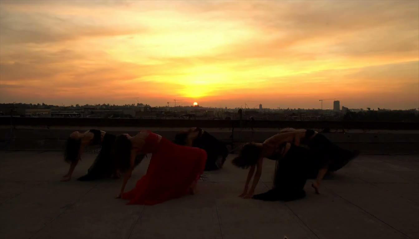 MiniMax H3 AI video example showing a group of dancers perform a choreographed routine on a rooftop at sunset